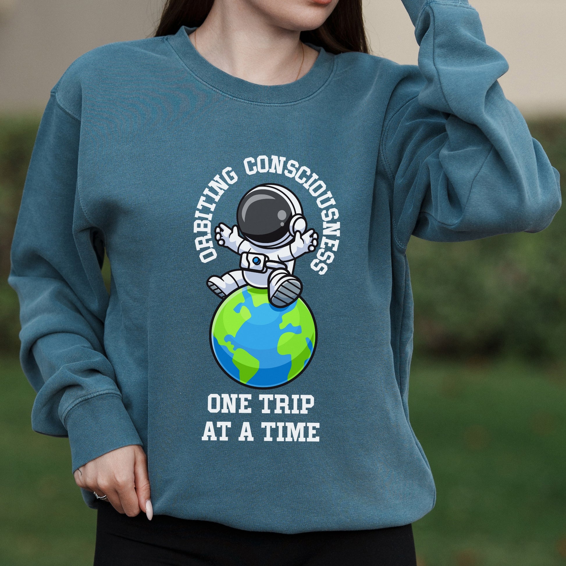 Orbiting Consciousness Astronaut Graphic with One Trip at a Time Text – Pigment Crewneck Sweatshirt